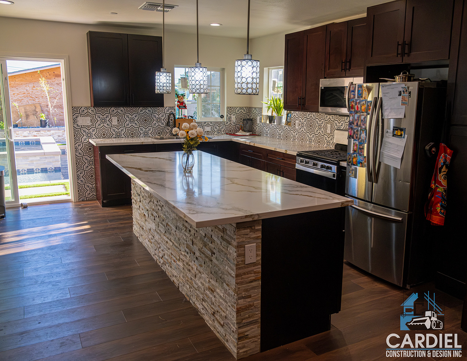 Remodeled kitchen showcasing sleek countertops, stainless steel appliances, and contemporary cabinetry.